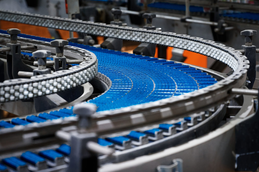 Empty plate conveyor belt and bottles at production line