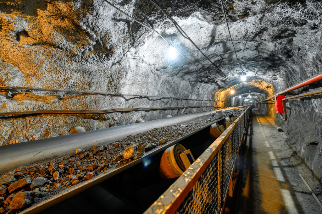 Belt conveyor in an underground tunnel. Transportation of ore to the surface